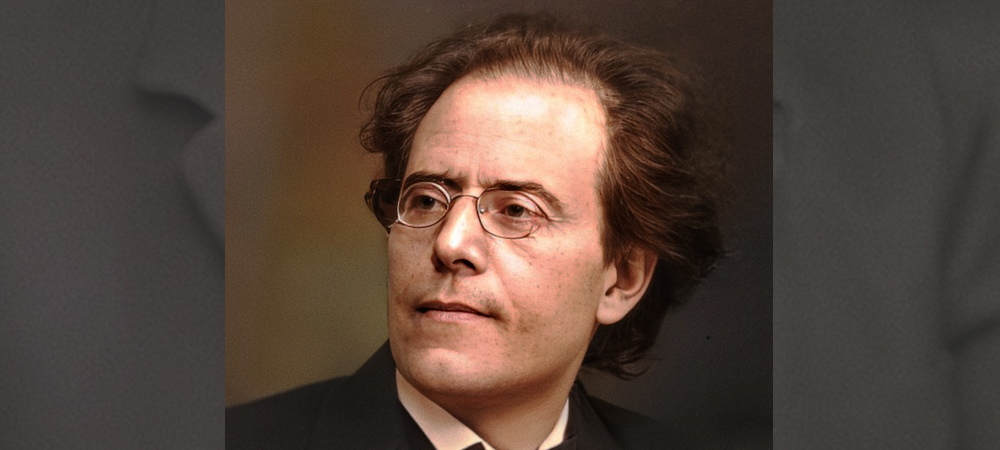 White man in glasses and black suite